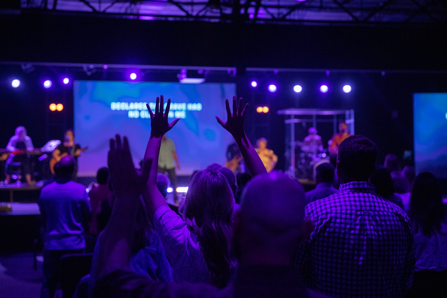 People worshiping with hands raised