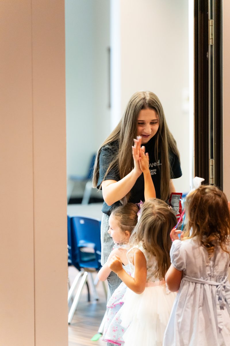 Volunteer greeting children